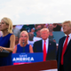 U.S. Rep. Mary Miller, of Illinois, speaks as former President Donald Trump stands behind her on stage at a rally at the Adams County Fairgrounds in Mendon, Ill.